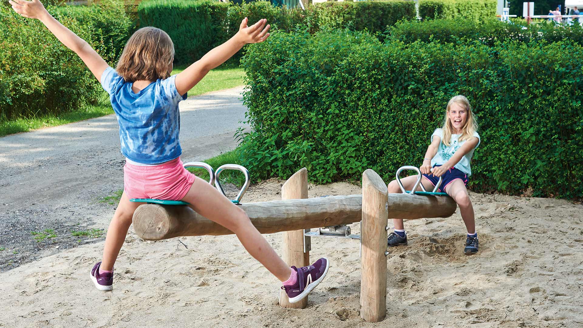 Holz-Wippe auf der zwei Mädchen spielen